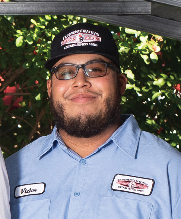 Victor Ponce smiling while in his work uniform